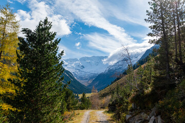 Obraz premium Mountain road through alpine valley with snowy mountains in the Krimmler Achental, Austria