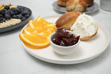 Top view of a breakfast spread featuring fresh fruits, glass of juice, blueberries, orange slices, apple slices, banana, and sunflower seeds, arranged neatly on plates. mindful eating and a balanced d
