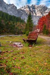 Colorful autumn landscape at Großer Ahornboden in the Karwendel Mountains, Austria – forest with fall foliage, rocky peaks and dramatic sky