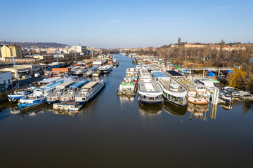Prague, Czech republic - January 08, 2024. Boat moored in safety port of Smichov and Cisarska louka...