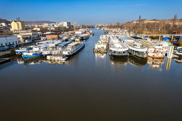 Fototapeta premium Prague, Czech republic - January 08, 2024. Boat moored in safety port of Smichov and Cisarska louka as a prevention during floods