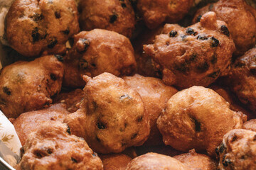 Oliebollen fresh Dutch pastry in a bowl. Close up of new years treat in the Netherlands. Happy New Year snack.