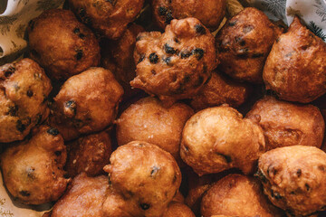 Oliebollen fresh Dutch pastry in a bowl. Close up of new years treat in the Netherlands. Happy New Year snack.