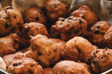Oliebollen fresh Dutch pastry in a bowl. New years treat in the Netherlands. Happy New Year snack.