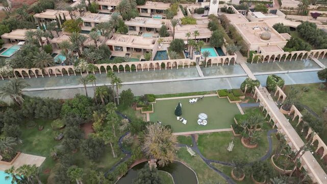An aerial view of a luxury hotel Palais Namaskar in Marrakesh, Morocco, December 28, 2024: with lush greenery, fountains, and elegant architecture 4K
