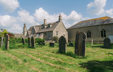 Old stone church cemetery in a rural countryside town basking in the afternoon sun