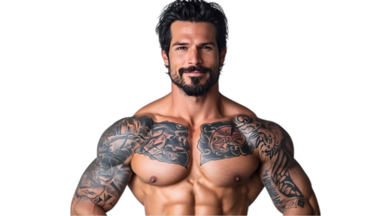 A muscular man with tattoos poses confidently, showcasing strength and fitness.