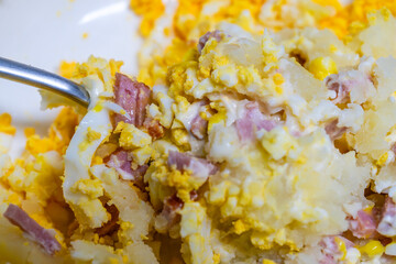 mixing the ingredients of the egg sandwich
