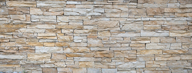 stone wall with layered natural stone blocks in different shapes and sizes