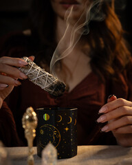 Spiritual ritual with sage smudging, celestial-themed cup, and mystical ambiance for cleansing...