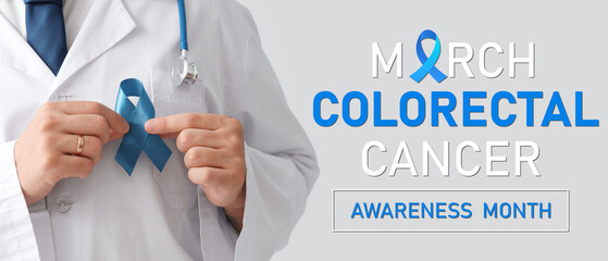 Male doctor with blue ribbon on light background, closeup. Prostate cancer awareness concept