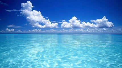 Obraz premium Serene Ocean Scene Under a Blue Sky With Fluffy Clouds