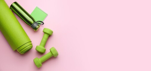 Dumbbells, yoga mat and bottle of water on pink background with space for text
