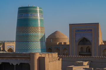 Ancient Kalta-Minor minaret and Muhammad Amin Khan madrasah on a cloudless September day. Khiva