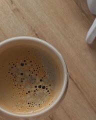 Cup of black coffee with foam.