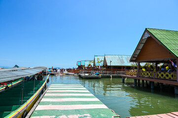 03 01 2024 - Ko Panyi, Thailand - Tourist boats docked at the swimming piers of restaurants at Ko Panyi, a swimming Muslim village at the Phang Nga bay in Thailand.