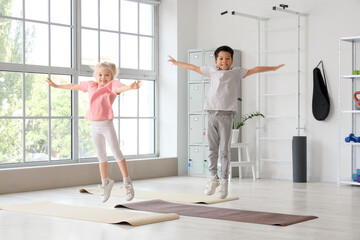 Obraz premium Cute little children jumping in gym