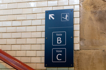 Signs Inside the Colmar France train station, directing passengers to gates and stairs