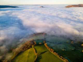Aerial view of low lying fog covering farmland and fields at dusk