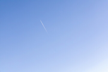 A single jet plane flying on the beautiful blue sky