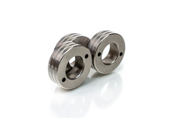 Set of metal washers on white background. Three round thick metal washers. industrial hardware for assembly and fastening.