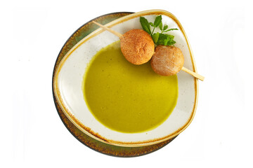 Cream of pea soup eating in a restaurant. Healthy dish, organic food, White background.