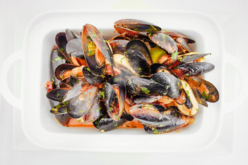 Baked moules with tomatoes, hot sauce, butter and parsley, Mediterranean cuisine, European food