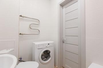 modern bathroom room with toilet and washing machine