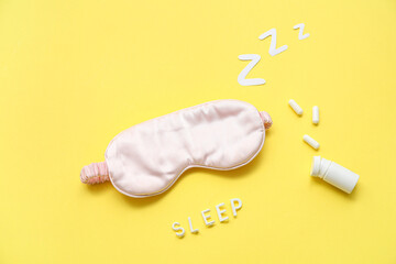 Composition with sleeping mask, pills and word SLEEP on yellow background