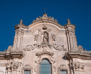 Church of saint francis of assisi in matera, italy, showing baroque facade and clear blue sky