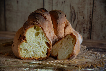 Matera bread, typical bread of basilicata region, italy, resting on rustic wooden table