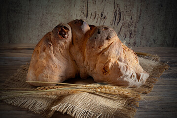 Matera bread, typical bread of basilicata region, italy, resting on rustic wooden table