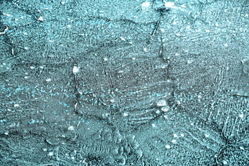 Shapes on the frozen surface of the lake in the winter with low temperatures in light blue color