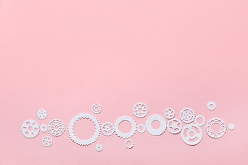 White paper gears on pink background