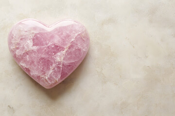 soft pink heart shaped rock on clean light surface evokes tranquility and love