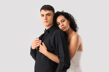 Young wedding couple hugging on light background. Yin Yang concept