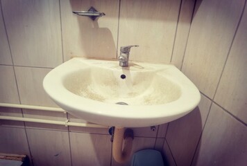 faucet on the sink. Heavy lime scale buildup and dirty on old tap and sink