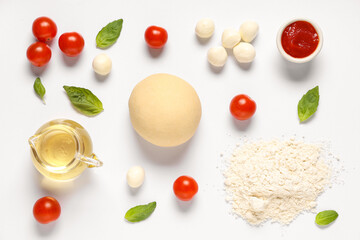 Raw dough and ingredients for preparing pizza with mozzarella on white background