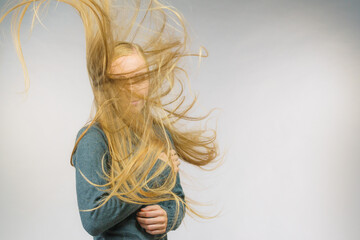 Girl with hair flying around her face