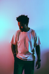 person in a tee shirt with cool hue lit background lighting