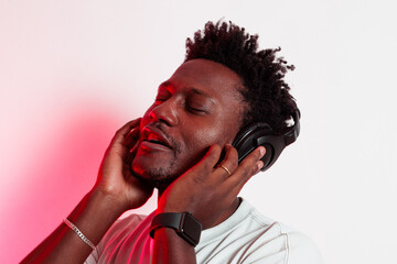 Portrait of black person enjoying music with headphones on