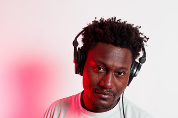Portrait of black person enjoying music with headphones on
