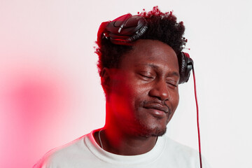 Portrait of black person enjoying music with headphones on