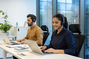 Support service, man and woman with headset, working with laptop, advising customers remotely,...