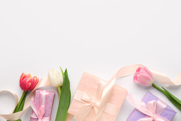 Gift boxes with tulips on white background. Happy Women's Day