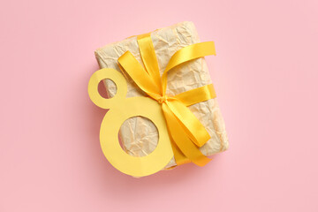Paper figure 8 with gift box on pink background. Happy Women's Day