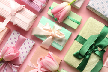 Gift boxes with tulips on pink background. Happy Women's Day