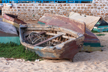 Old fish boat on the sand