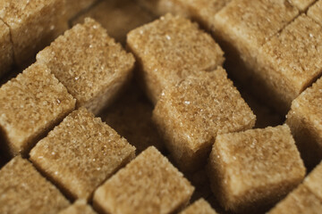 Macro cubes of brown cane unrefined demerara sugar.