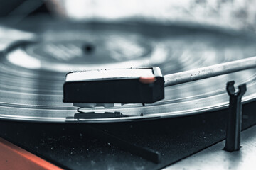 Vintage record player spinning a vinyl disc in a cozy indoor setting during a quiet afternoon
